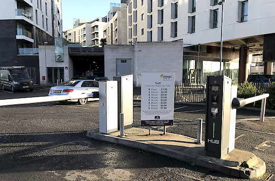 entry lane of the Odyssey car park, with tariff sign and automated barrier, and Jupiter station