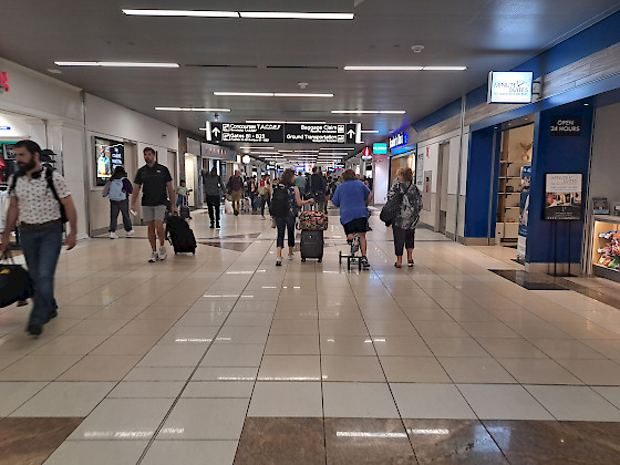 people walking in an airport hallway